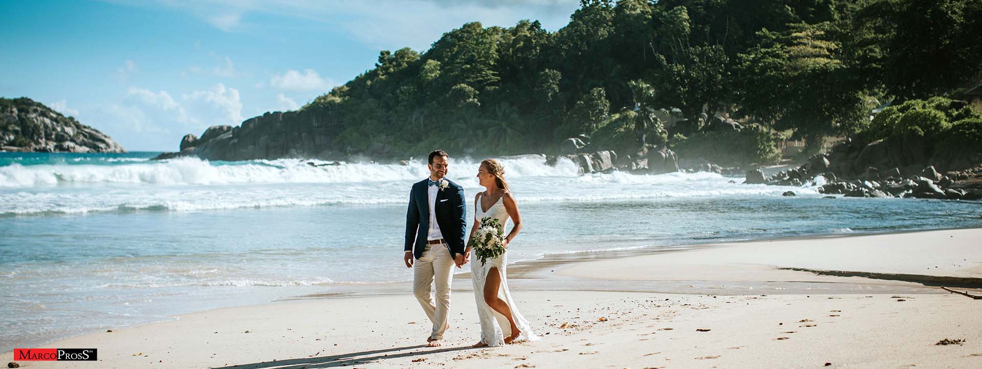 wedding in seyschelles - happy couple walking on the beach - Mahe Island